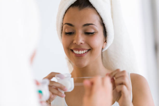istock Pretty young woman using dental floss in a home bathroom. 961798656