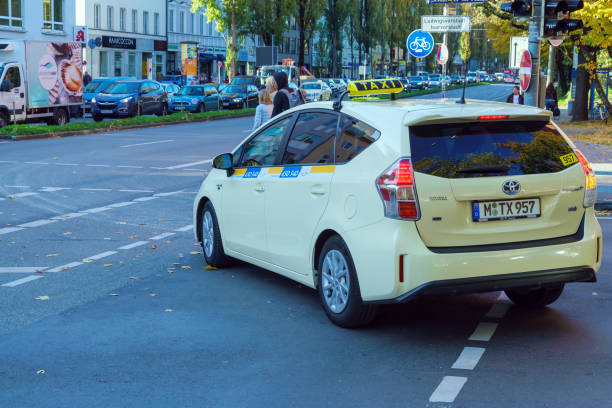 Munich, Germany - October 20, 2017:  Yellow taxi car on the city street in motion