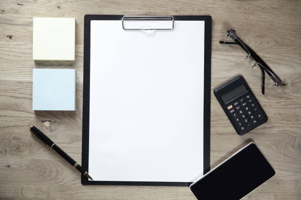 istock clipboard with blank sheet smartphone and calculator on wooden background 961802676