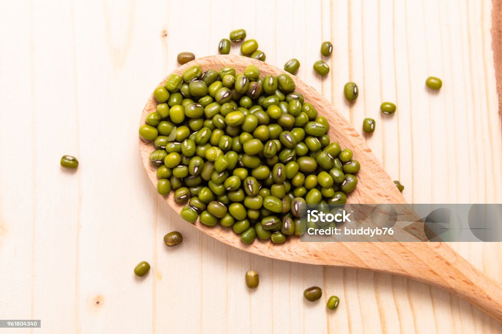 Top view organic green mung beans in wood spoon on wooden background Mung Bean Stock Photo