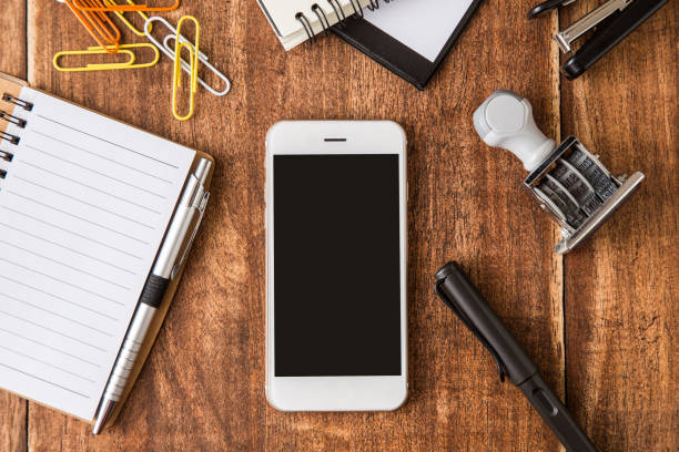 istock smartphone and equipment office on wood desk top view 961808500