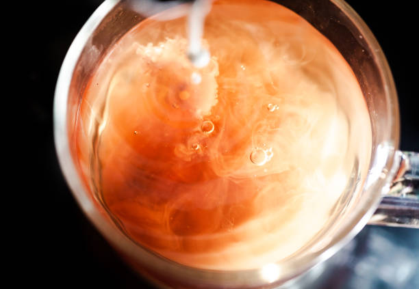 istock A nice warm cup of tea, shot in a studio, milk swirls in tea 961808928