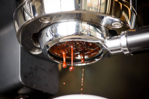 Close-up of espresso pouring from coffee machine. Professional coffee brewing