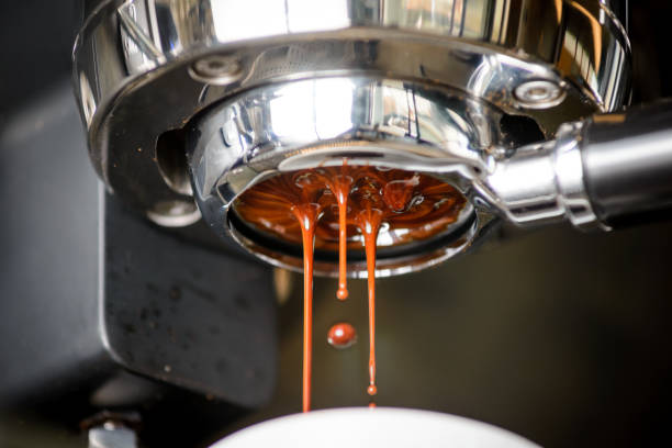 Close-up of espresso pouring from coffee machine. Professional coffee brewing