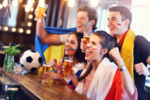 istock Group of friends watching soccer in pub 961814816