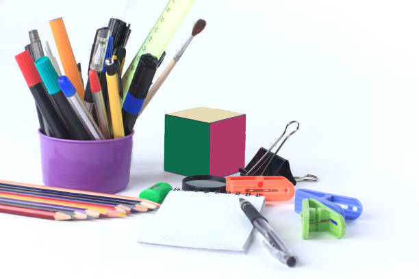 istock Rubik's cube and school supplies .isolated on white background 961814892