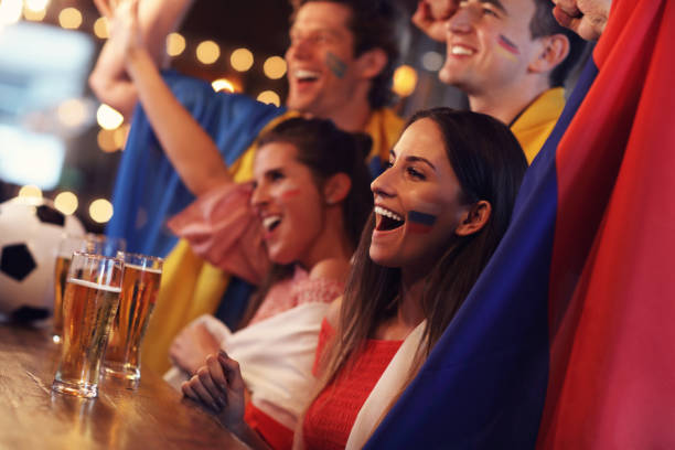 istock Group of friends watching soccer in pub 961818358
