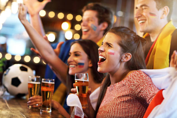 istock Group of friends watching soccer in pub 961819144