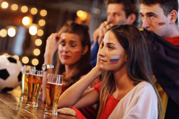 istock Group of friends watching soccer in pub 961819676