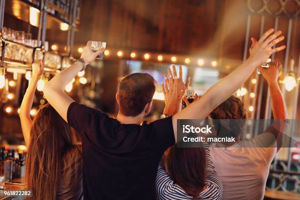 Group Of Friends Watching Soccer In Pub Stock Photo - Download Image Now - Bar - Drink Establishment, Sport, Party - Social Event