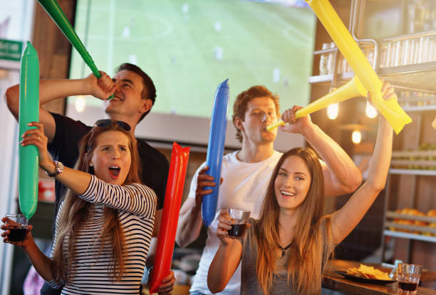 istock Group of friends watching soccer in pub 961822534