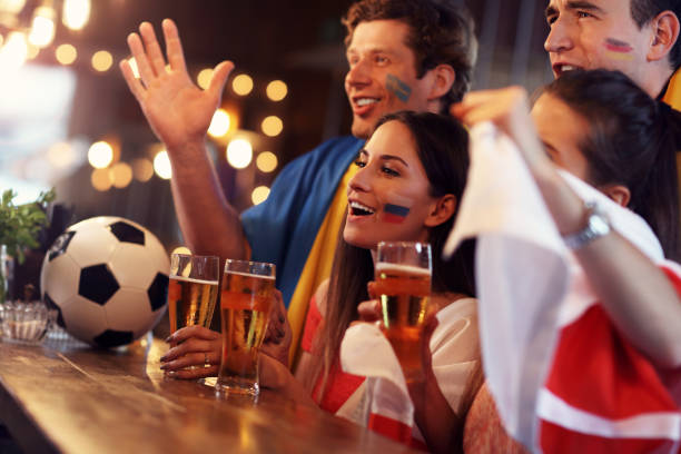 istock Group of friends watching soccer in pub 961823036