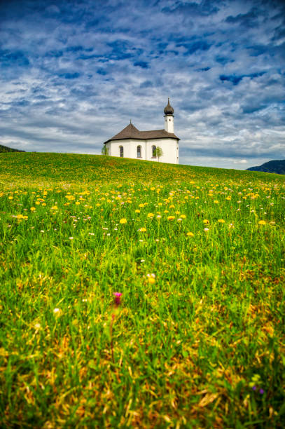 High Dynamic Range shot of the Alp mountains with a small Sankt Anna church on the hill; Achenkirch, Austria
