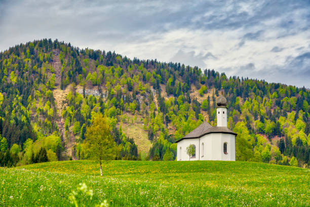 istock Idyllic landscape with small church in the Alps (HDRi) 961823794