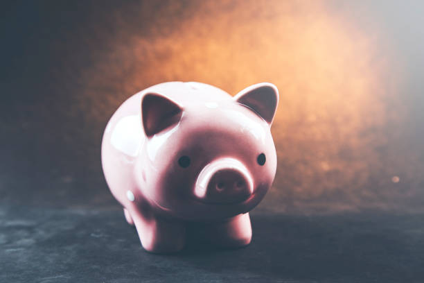 istock pink piggy bank on table 961824570