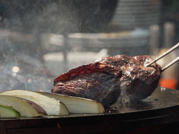 istock Assorted delicious grilled meat with vegetables over the coals on barbecue 961829038