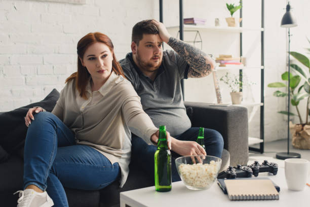 istock size plus boyfriend and girlfriend watching tv at home 961830320