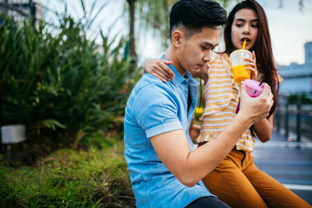 istock Couple enjoying drinking juice at the public park 961836684