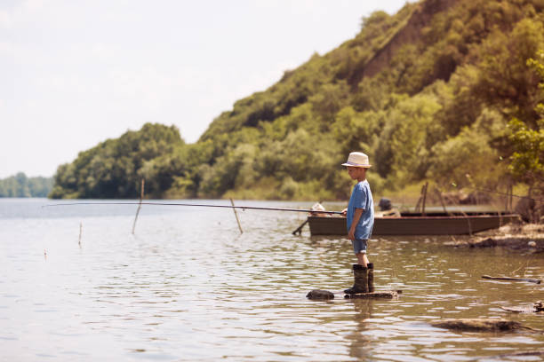 istock Young boy fishing on the river 961838492