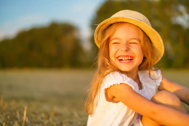istock Little girl in a field with hay rolls 961840816