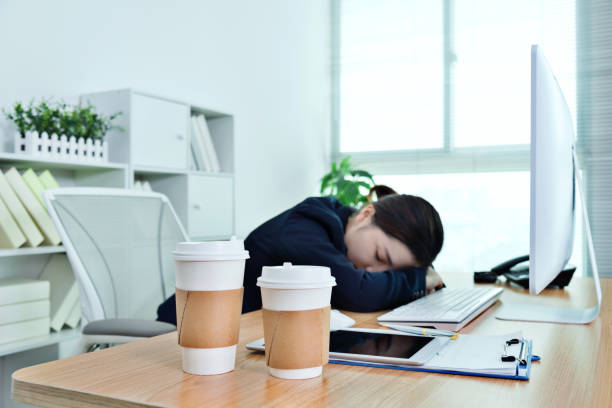 istock Tired businesswoman sleeping on desk 961841192
