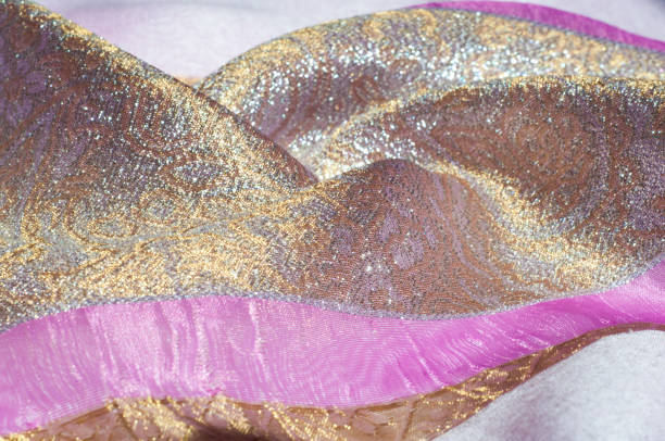 istock Texture, background, pattern. Combined silk white fabric and gold and silver damask fabric, pink ribbons 961841608