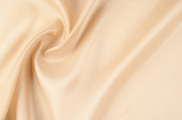 istock Texture background of fabric. Beige fabric. Silk fabric wallpaper texture background pattern in sepia pastel yellow cream beige tint: Lovely natural silk textured textile 961841728