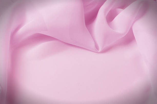 istock Texture, background, pattern. Silk fabric pale pink, abstract folds 961841760