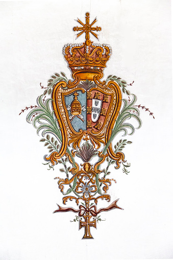 Obidos, Portugal. Baroque fresco of the Portuguese Royal Coat of Arms with Vatican. Obidos is a medieval town inside walls, and very popular among tourists.