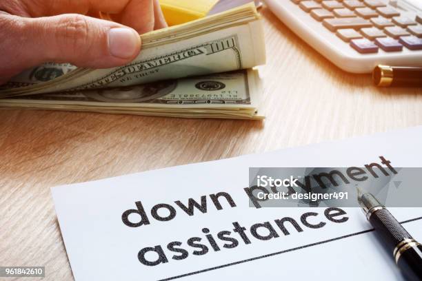 Down Payment Assistance Form And Dollar Banknotes Stock Photo - Download Image Now - Moving Down, Paying, Assistance