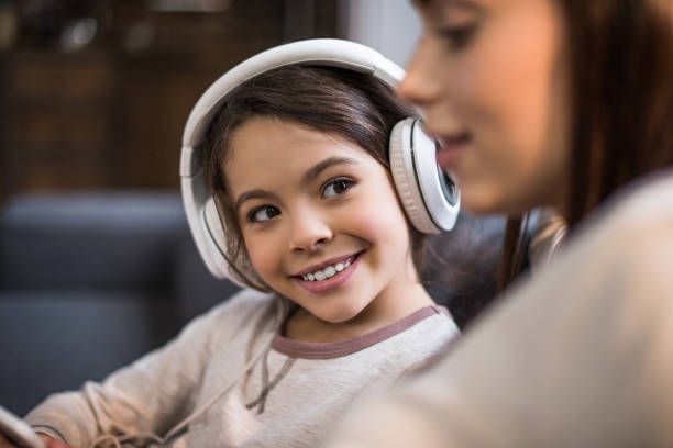 istock smiling daughter in headphones 961845498