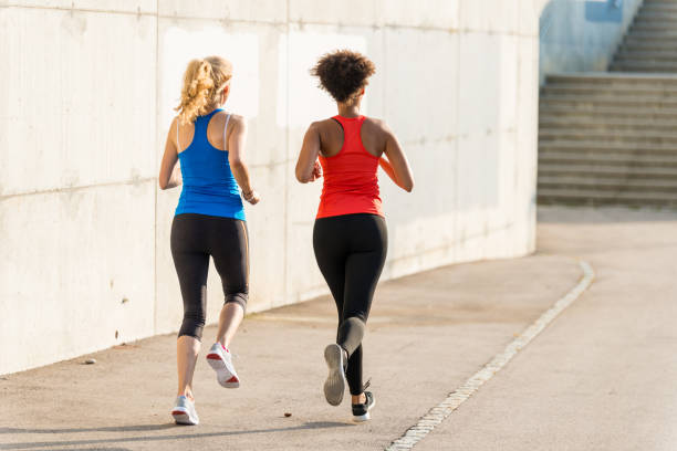 istock Two female athletes running together 961846890
