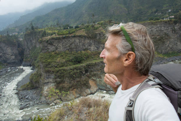 istock Male hiker explores river above jungle 961850002