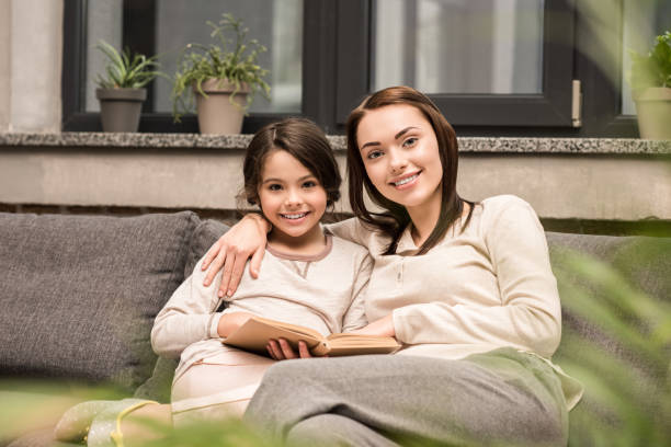 istock smiling family with book 961856060