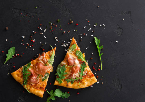 istock Pizza with prosciutto and rocket salad copy space 961857474