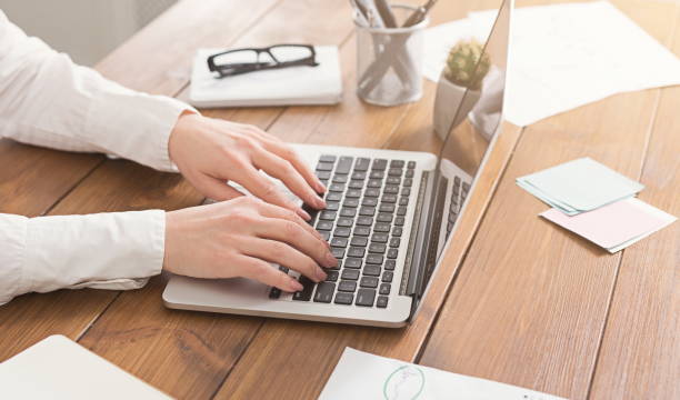 istock Woman working at office, hand on keyboard close up 961860176