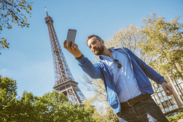 istock Happy young man taking a selfie photo in Paris 961861076