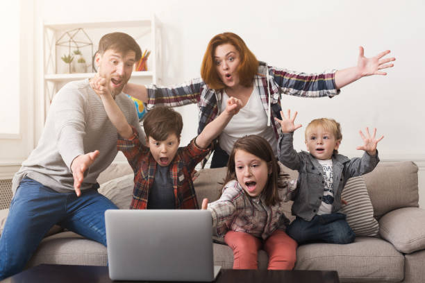 Family watching game together and cheering team