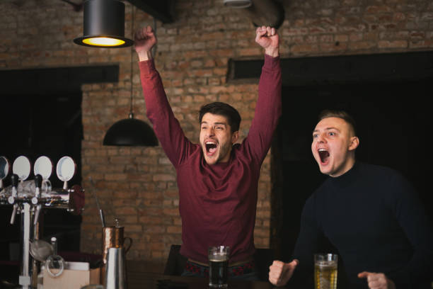 istock Happy men shouting while watching football match in bar 961867102