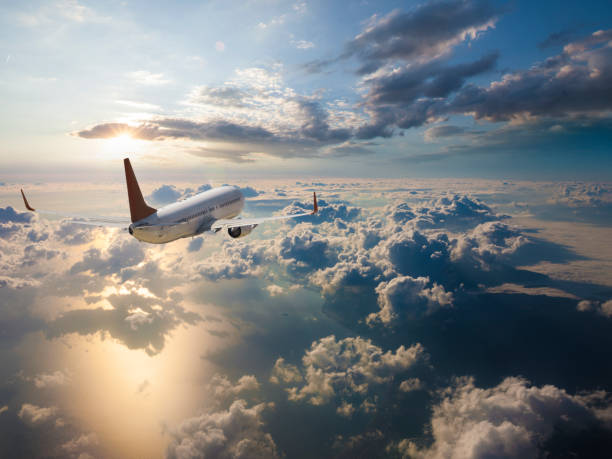 istock Passenger airplane flying above clouds at sunrise 961867456