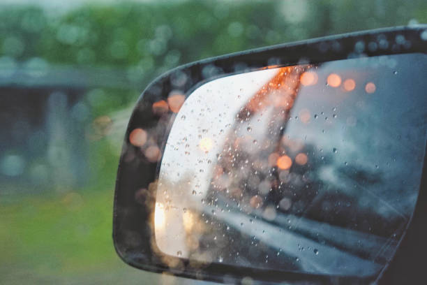 istock Rear view mirror black color with bokeh light from a cars. 961867664
