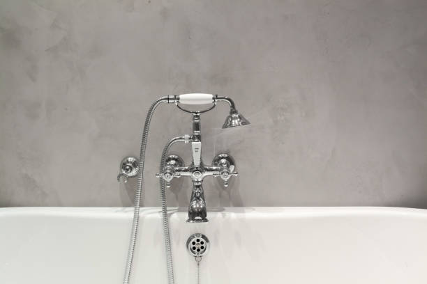 istock Bright bathroom with new textured wall and plumbing. 961869798