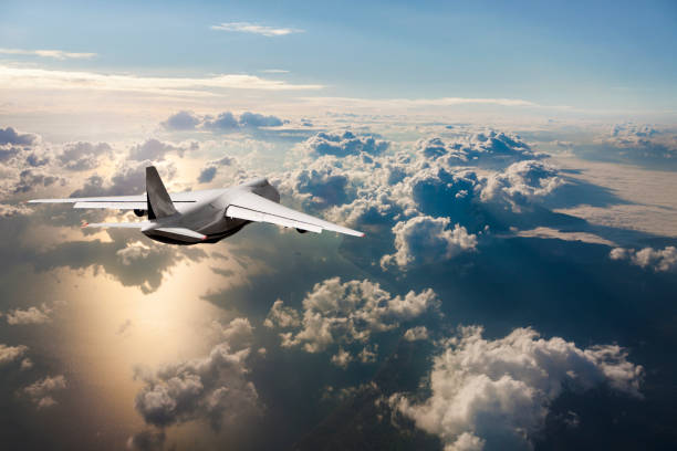 istock Cargo Airplane flying above the clouds at sunrise 961870720