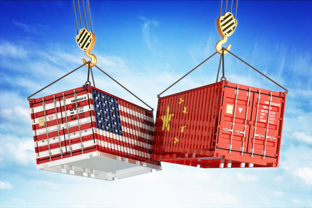 Economic trade war between USA and China Freight transportation concept, cargo containers with USA and China flags hoisted by crane hooks on blue cloudy sky background tariff stock pictures, royalty-free photos & images