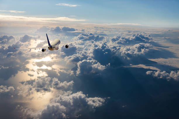istock Passenger airplane flying above clouds at sunrise 961871134