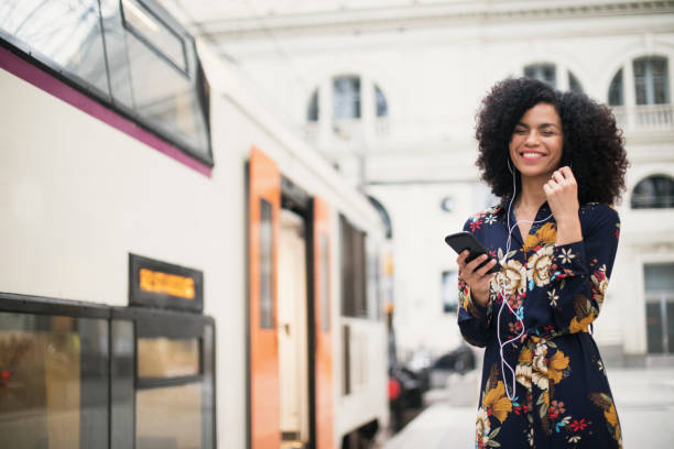 istock Woman at the train station using smart phone 961876072