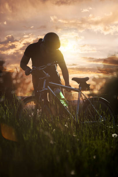 Young man with his bike in nature