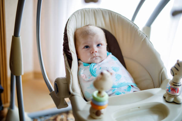 istock Cute adorable newborn baby sitting in swing 961877004