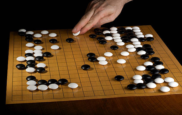 Player Makes a Move in Professional Go Board Game stock photo