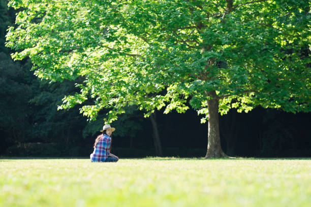 istock Woman relaxing in the field 961885622